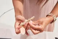 Hands holding a Cuyana Travel Jewelry Case