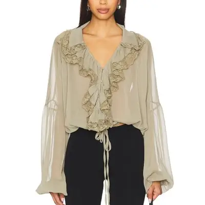 model wearing a drapey sheer sage blouse