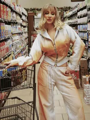 Woman wearing ombre denim set while standing in grocery aisle