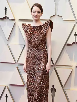 Emma Stone wears a brown beaded Louis Vuitton gown with structured shoulders to the 2019 Oscars