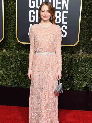Emma Stone wears a peach Louis Vuitton dress with silver scalloped details to the 2019 Golden Globe Awards