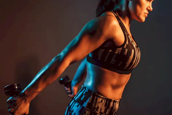 Woman workout in gym with dumbbells