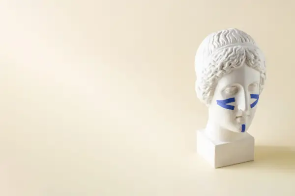 Blue tapes for the face on the bust on a beige background. Non-surgical facelift, rejuvenation. Copy space