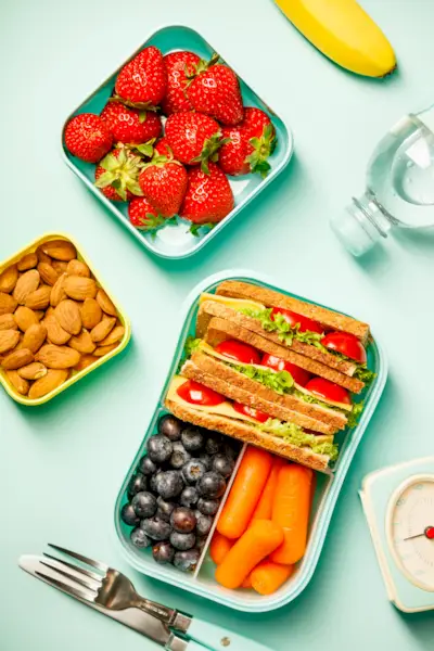 Creative flat lay with healthy lunch and office or school supplies