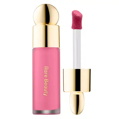 Rare Beauty blush tube in bright pink shade and gold cap