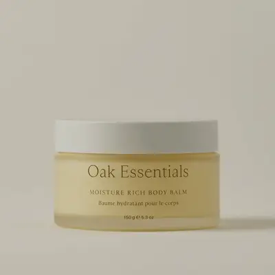 A jar of Oak Essentials Moisture Rich Body Balm shown against a light neutral background