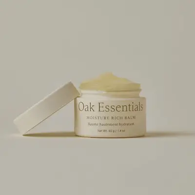 A jar of Oak Essentials Moisture Rich Balm with the lid slightly tilted
