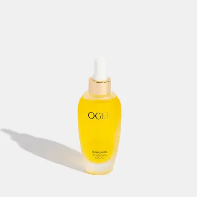 Yellow face oil tube with white dropper and Ogee gold branding