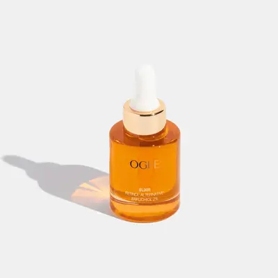 Orange skincare bottle with gold Ogee branding