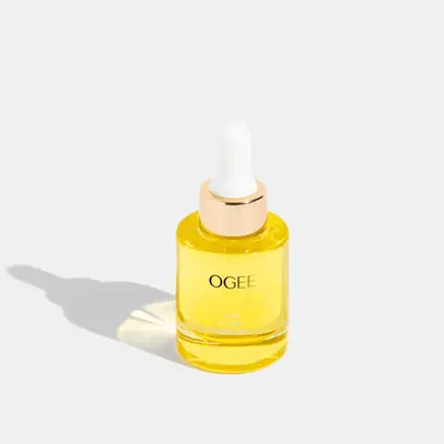 Yellow Vitamin C skincare bottle with gold Ogee branding