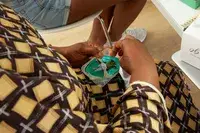 Hands opening package of Opalescence Go Tooth Whitening Prefilled Trays