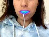 A person using the Snow Teeth Whitening LED Light