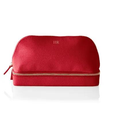 red toiletry bag with monogram on white background