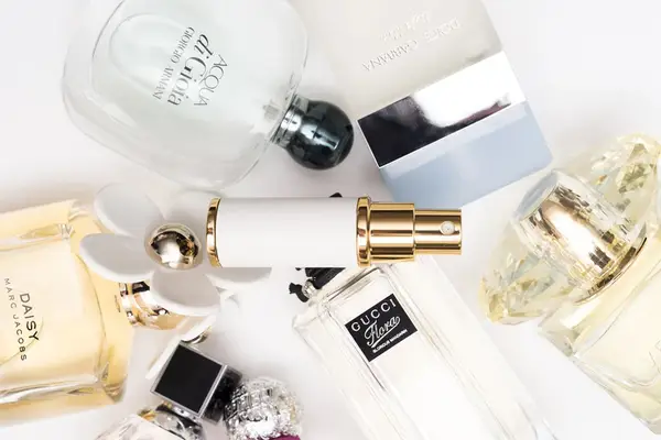 Collage of several bottles of perfume from a Fragrance Club subscription on a white background