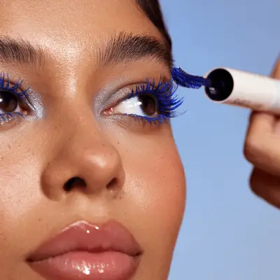 Model wearing blue mascara