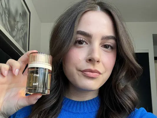 Snif Me Fragrance being held and displayed by woman