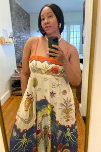 A woman wearing the Alemias Surrealist Summer Dress from Rent the Runway