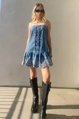 A woman wearing the Damson Madder Lana Drop Waist Mini Dress from Nuuly