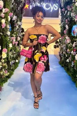 A woman wearing the Anthropologie Strapless Floral Organza Mini Dress from Nuuly