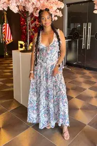 A woman wearing the For Love and Lemons Audrey Floral Maxi Dress from Nuuly