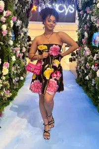 A woman wearing the Anthropologie Strapless Floral Organza Mini Dress from Nuuly