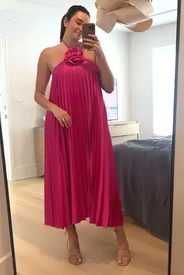 A woman wearing the Delfi Collective Gisele Dress from Fasionpass