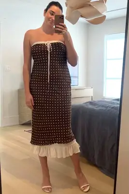 A woman wearing the For Love Lemons Daisy Mae Midi Dress from Fashionpass