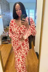 A woman wearing the Sister New York Floral Dress from Rent the Runway