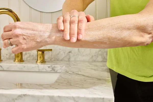Person applies Acure Seriously Soothing 24hr Moisture Lotion to their forearm