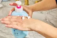 person dispensing eos Shea Better 24H Moisture Body Lotion to back of hand