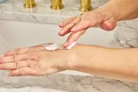 eos Shea Better 24H Moisture Body Lotion on back of hand