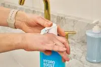 person pumping Neutrogena Hydro Boost Body Lotion Gel Cream to back of hand
