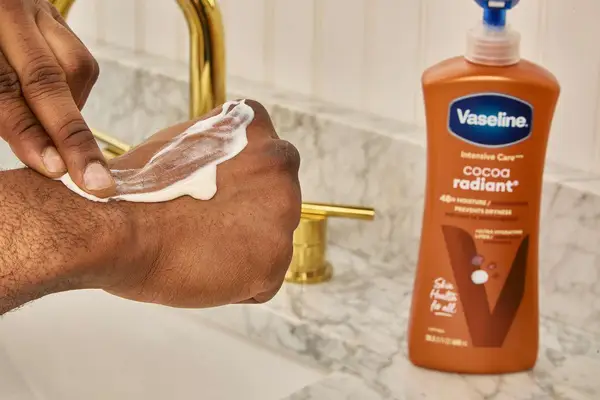 Vaseline Intensive Care Cocoa Radiant Smoothing Body Butter on back of person