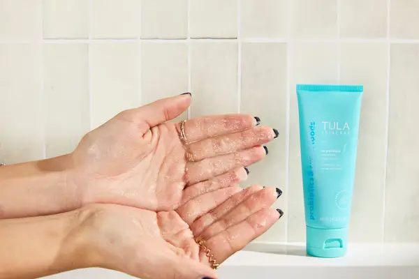 Tula Skincare So Polished Exfoliating Sugar Scrub on a person