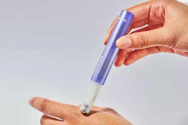 Hand using the Hero Cosmetics Lightning Wand Dark Spot Brightening Serum on their other hand