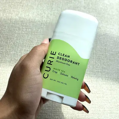 Curie Deodorant Stick in hand
