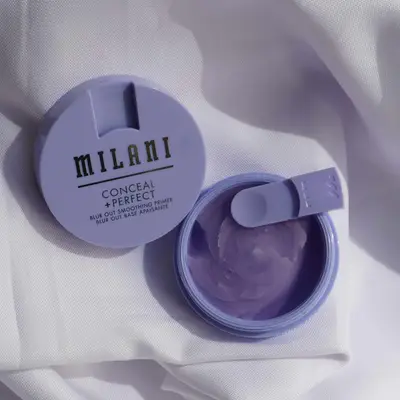 Milani Cosmetics Conceal + Perfect Blur Out Smoothing Primer on fabric background with spatula