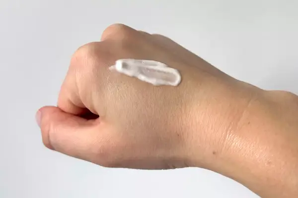 Rhode Beauty Barrier Restore Cream on the back of a person