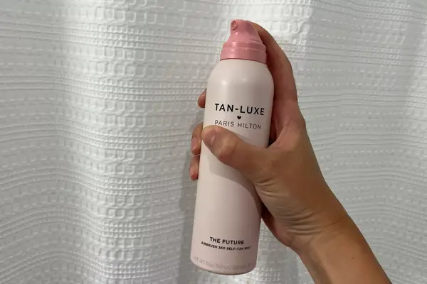 a photo of a person spraying the Tan-Luxe The Future Air Brush 360 self-tanner