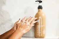 A person lathering the Luseta Beauty Jamaican Black Castor Oil Shampoo in their hands