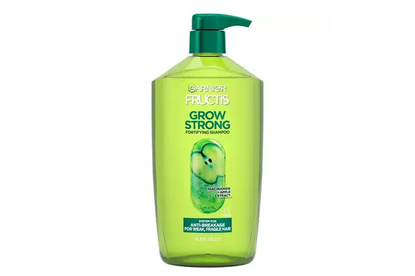 a person pouring Nécessaire Rosemary Shampoo into their hands